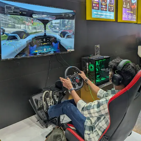 A visitor playing a racing simulator